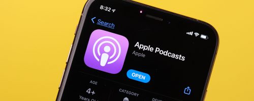 Phone showing Apple Podcasts against a yellow background.